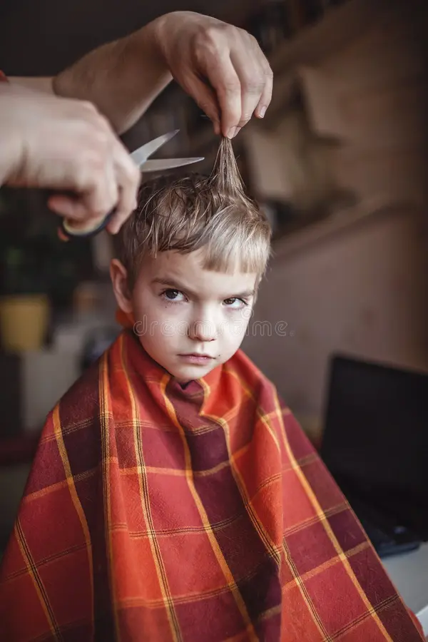 father cutting child hair