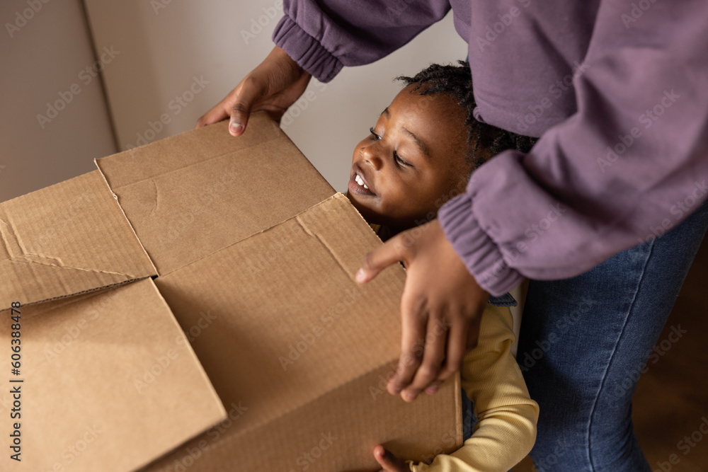 teen helping carrying box
