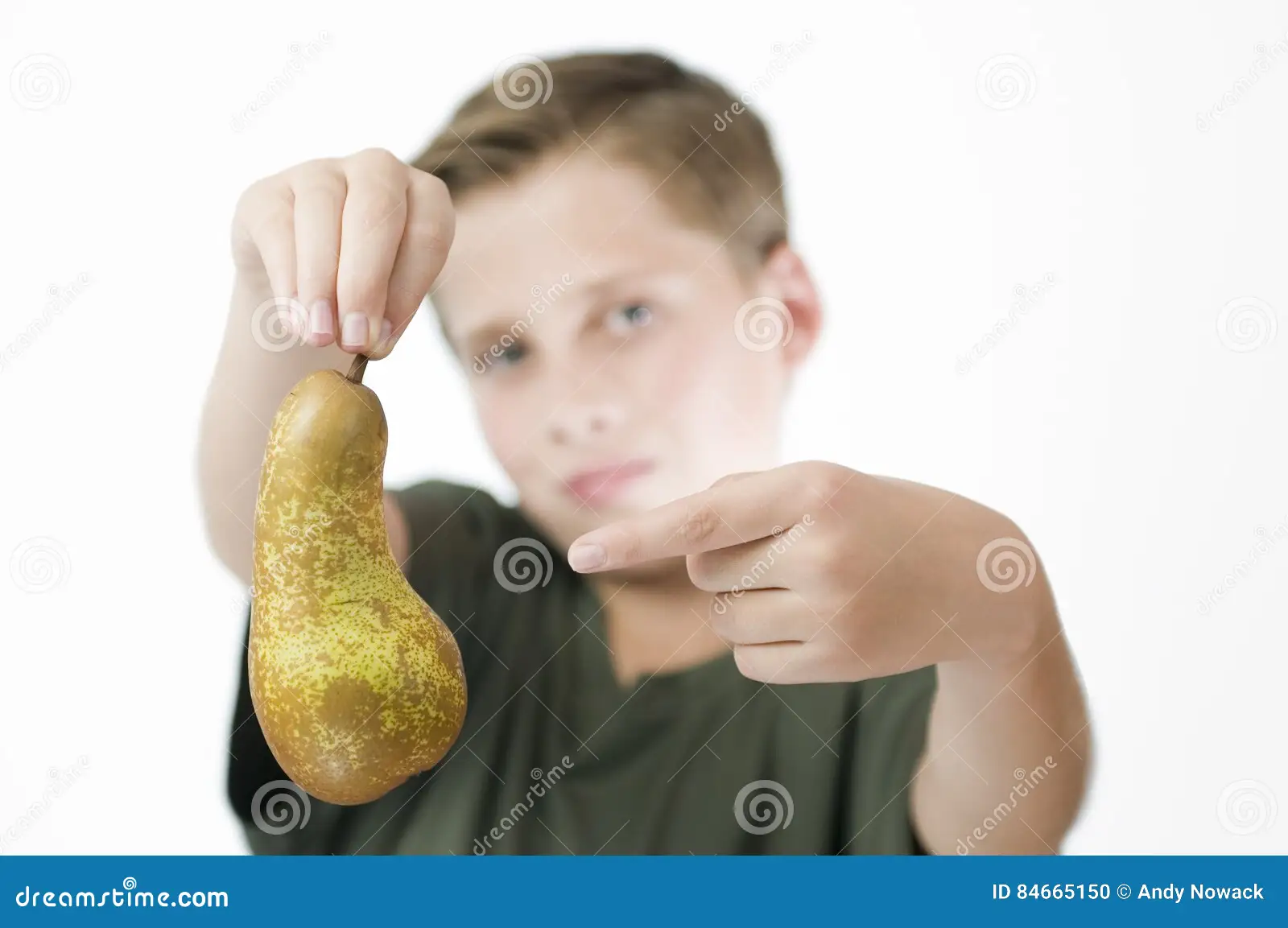 child pointing at pear